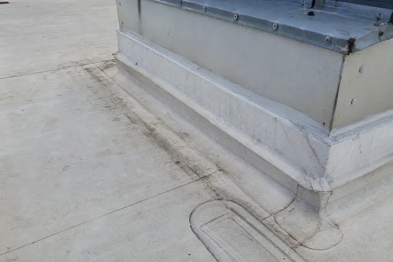 Commercial roof seam and curb detail reviewed for leak repair planning